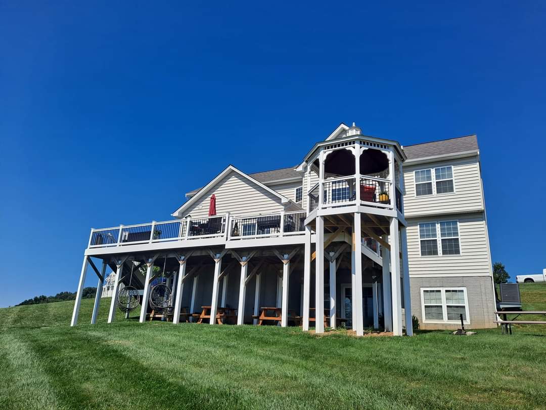 Elevated multi-level deck with gazebo-topped overlook and covered patio seating area underneath