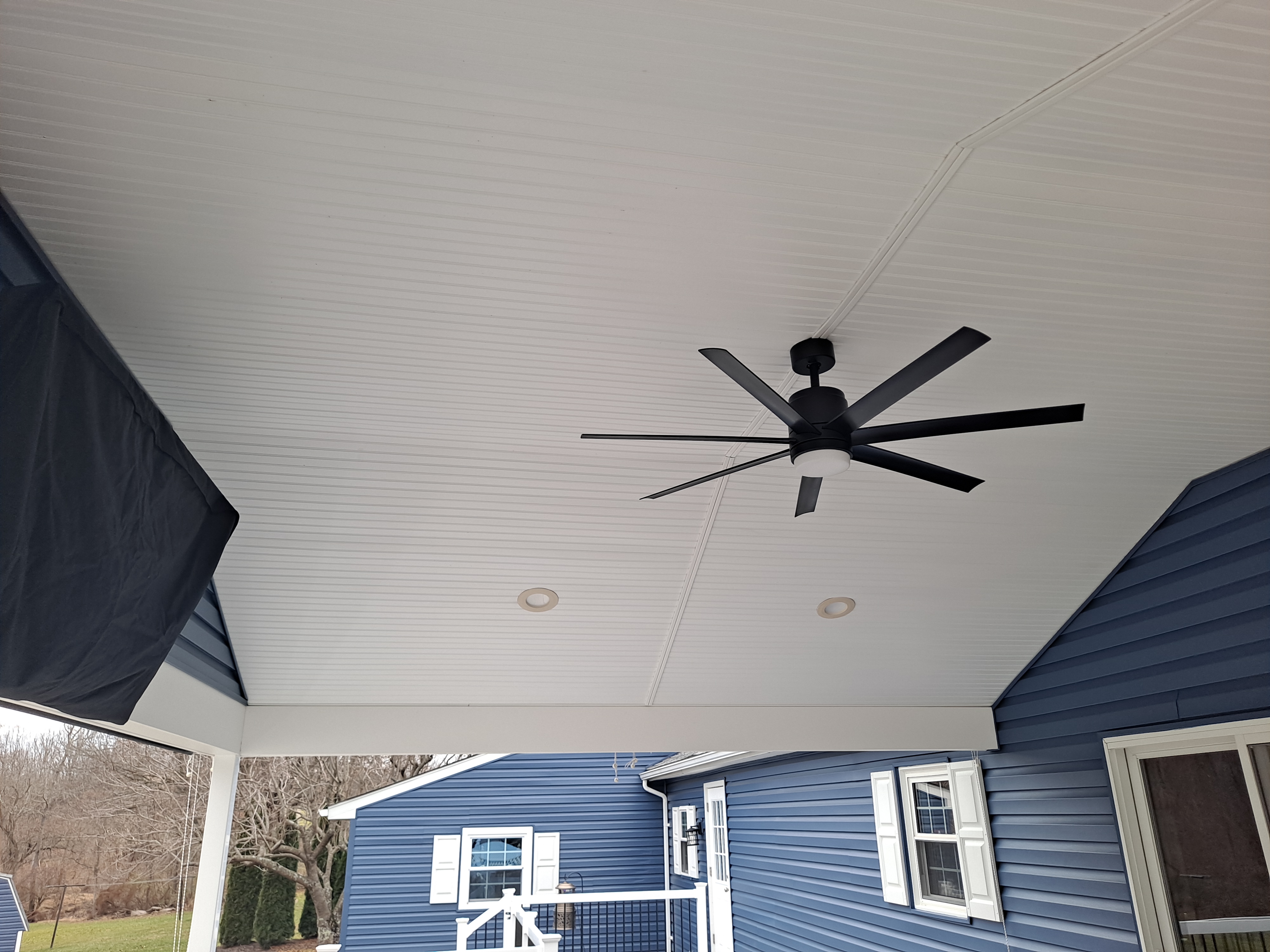 Covered porch ceiling detail with large fan