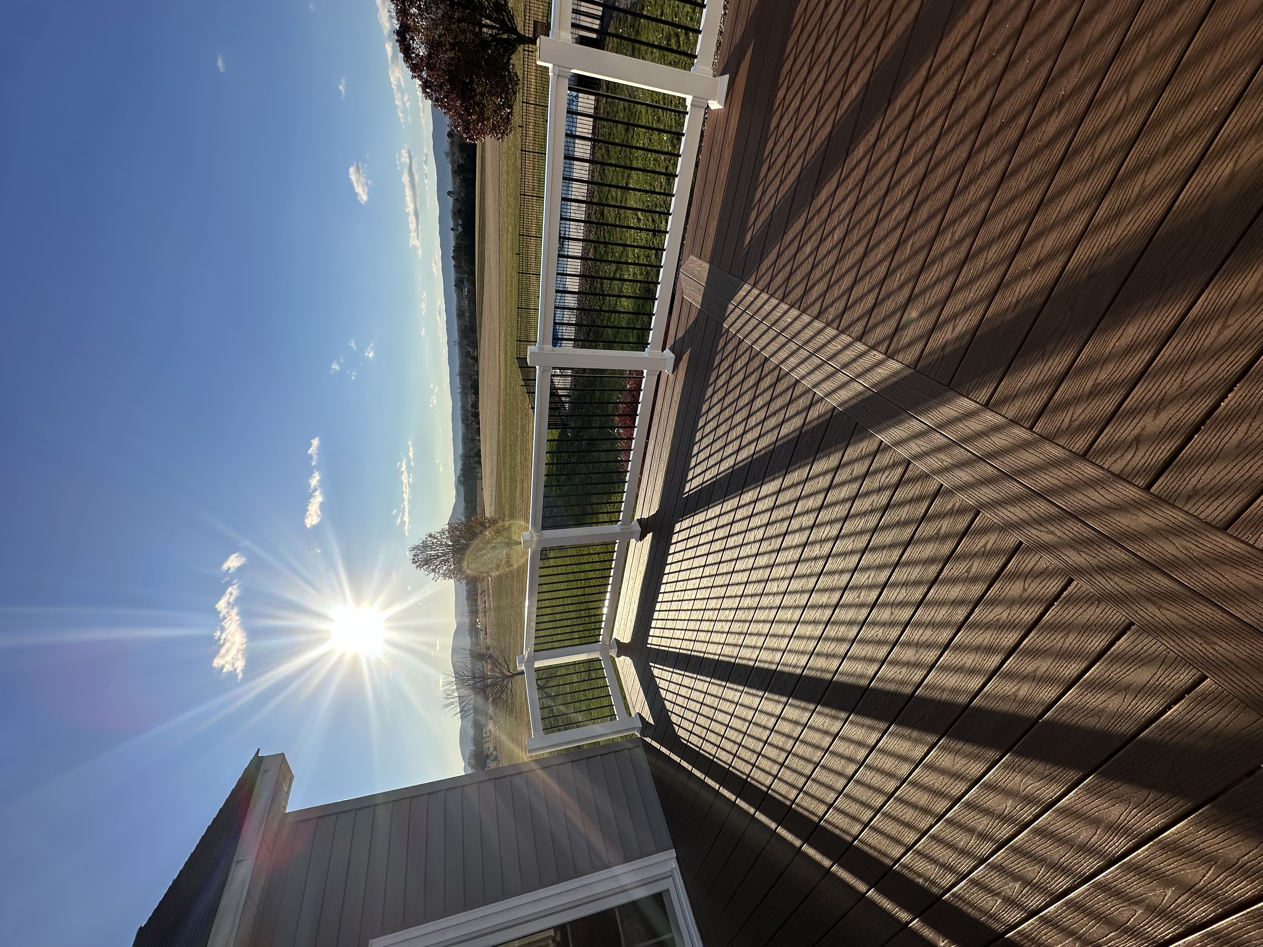 Deck addition at sunset overlooking farmland and mountains