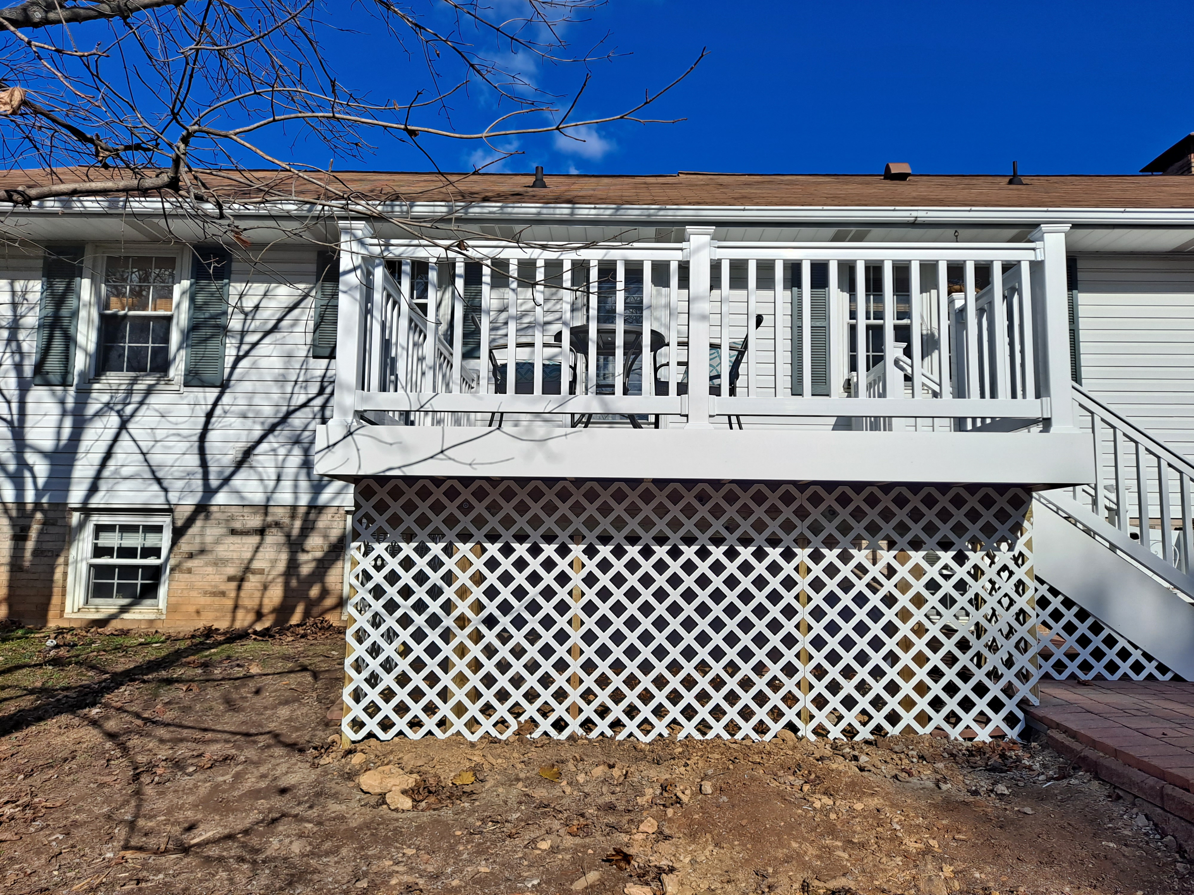Elevated deck with white vinyl lattice skirting