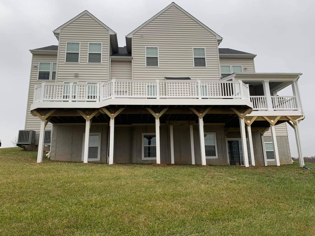 Large elevated deck with lattice skirting and covered porch section