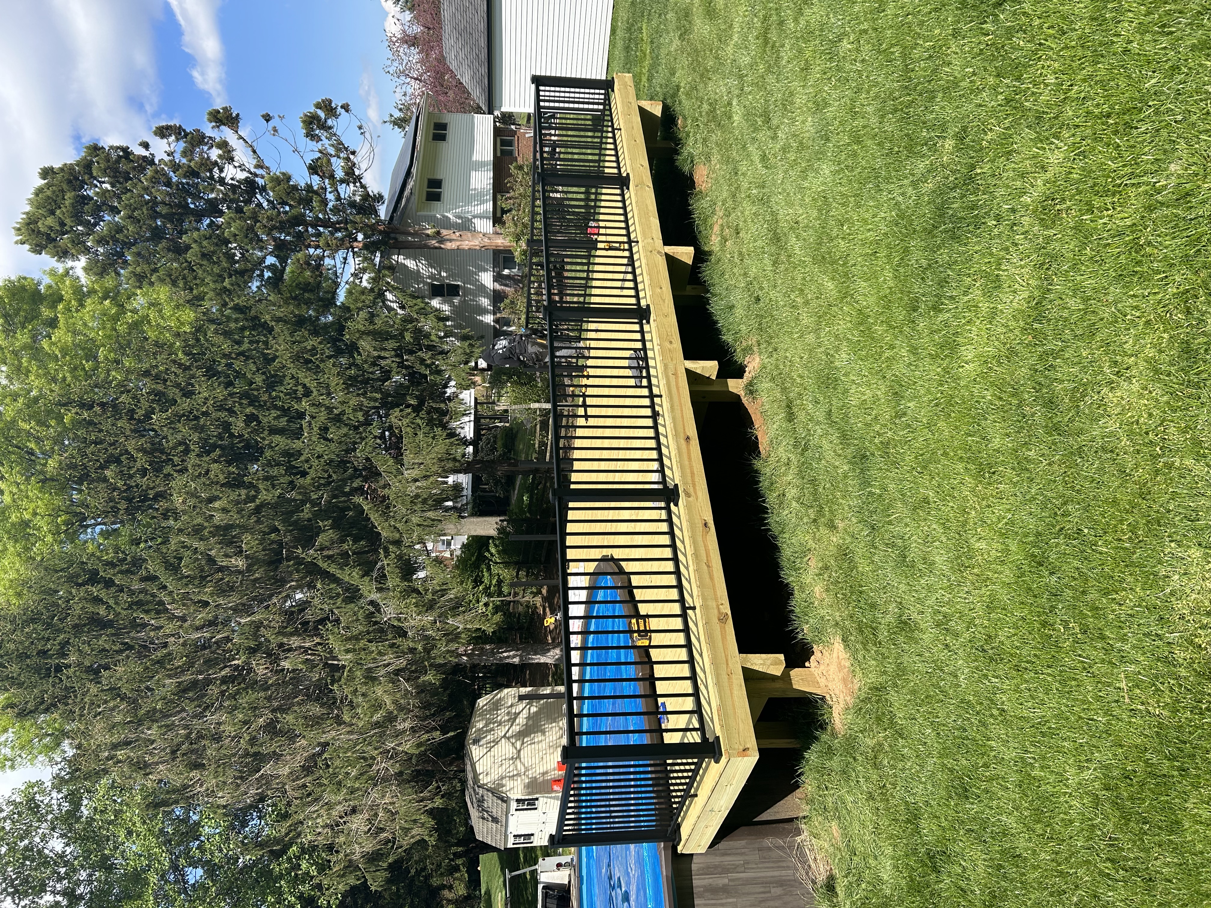 Pool deck with black aluminum railing, full-length view