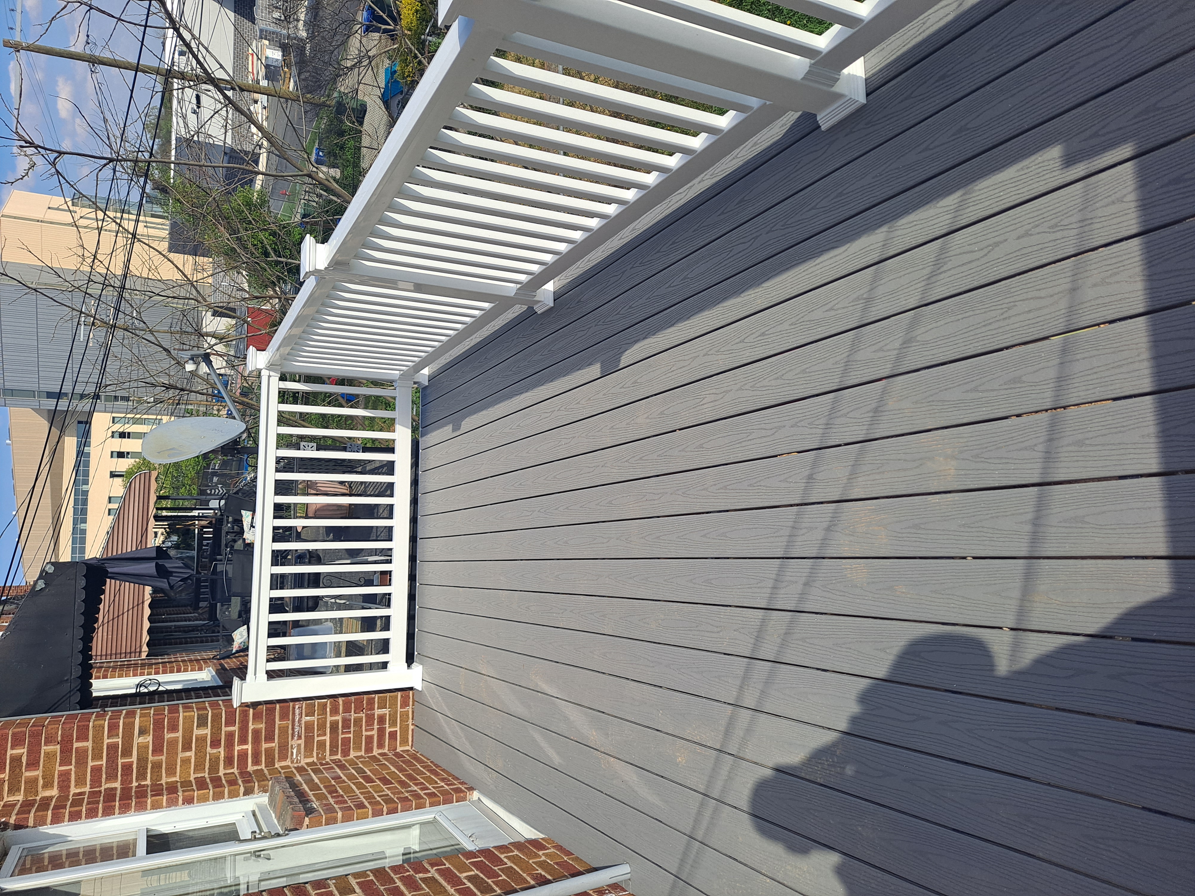 Rooftop deck addition with white vinyl railing