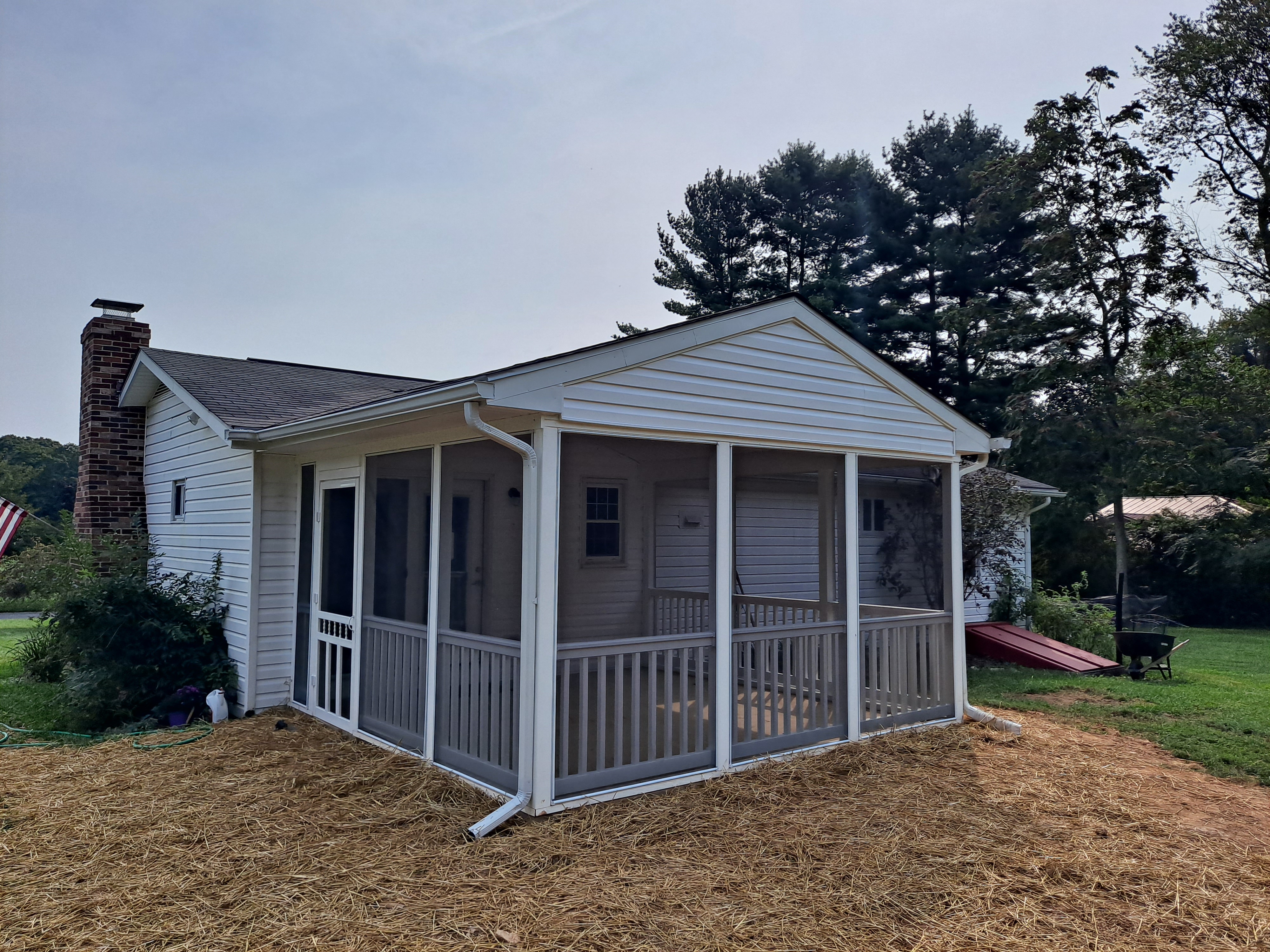 Screened-in porch addition with new siding and gutters