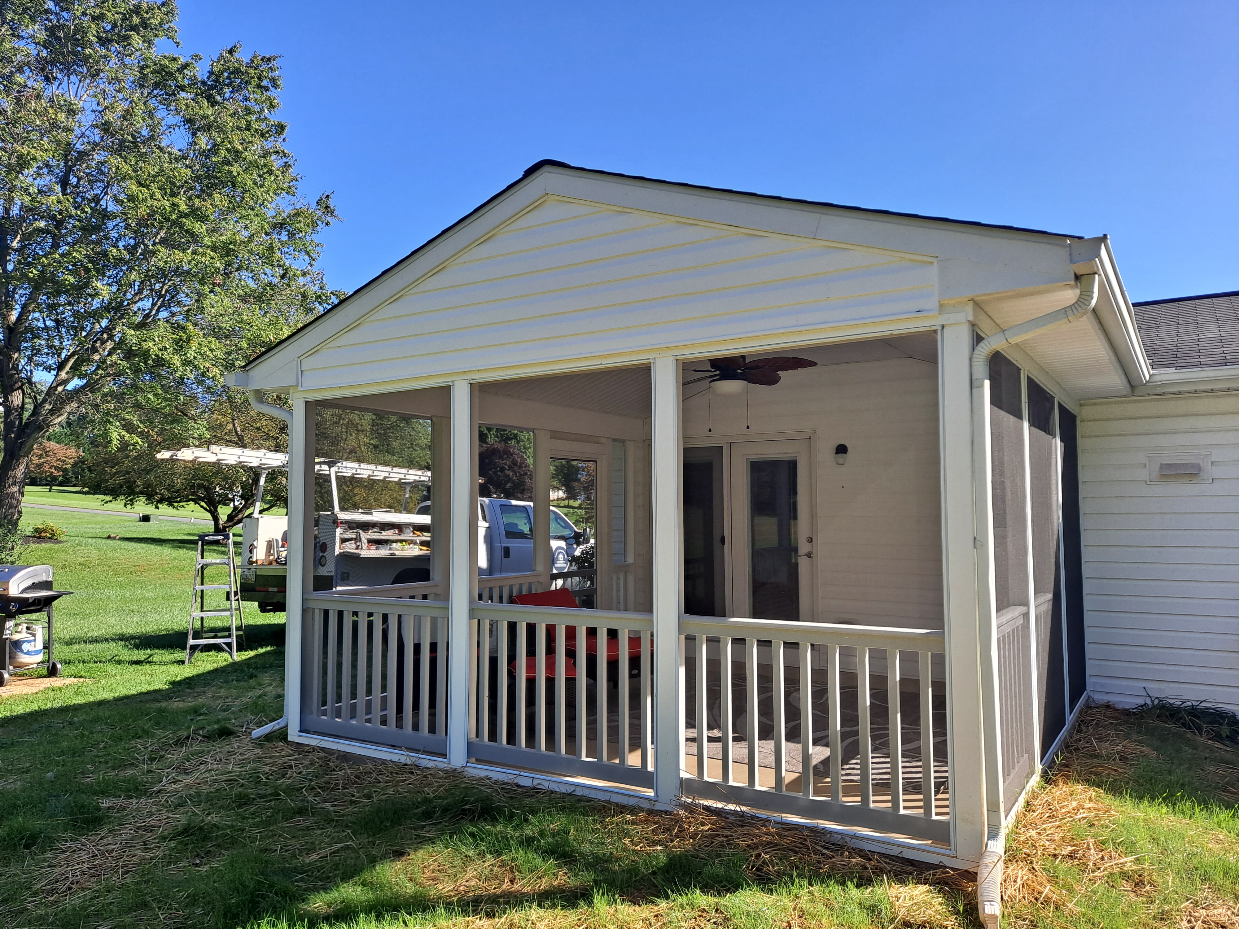 Screened-in porch addition with gabled roofline