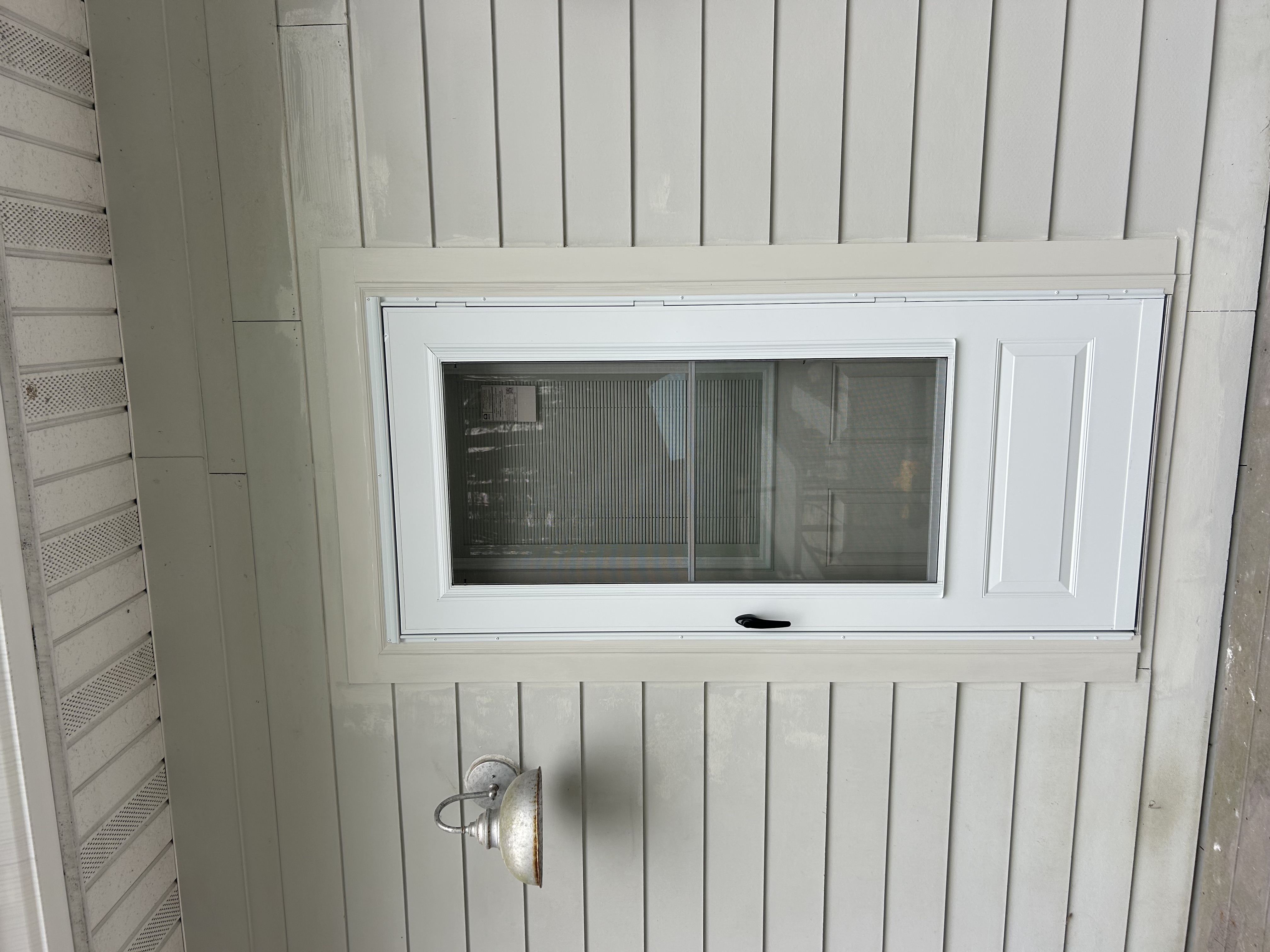 New storm door installation, exterior view with fresh trim
