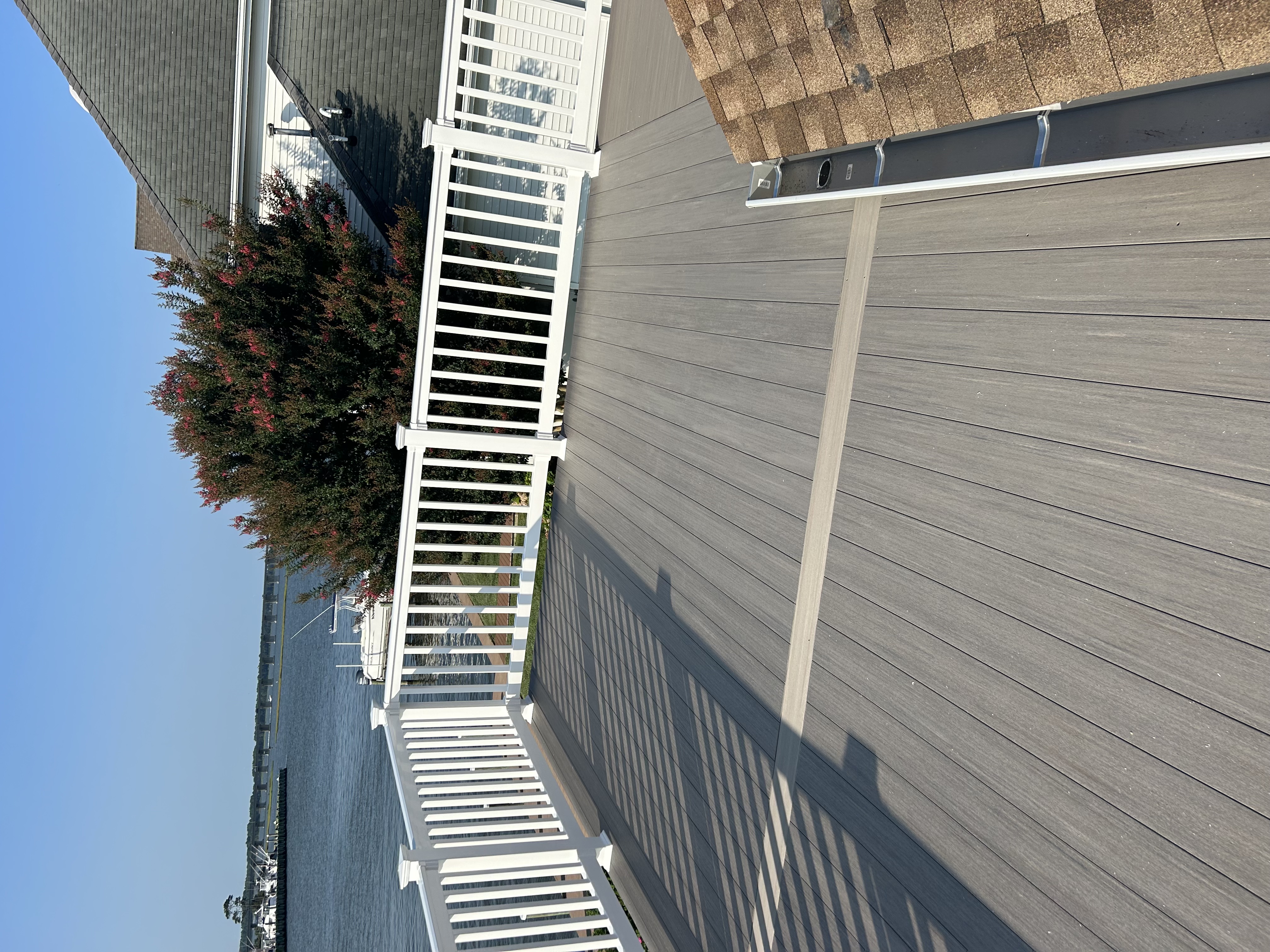 Waterfront deck with composite decking and a marina view