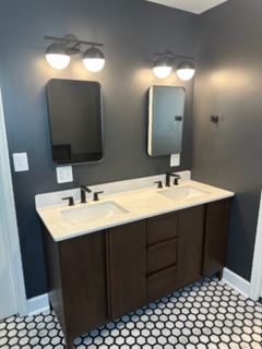 Bathroom remodel with dark double vanity and hexagon tile floor