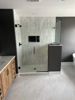 Bathroom remodel with glass shower and freestanding tub
