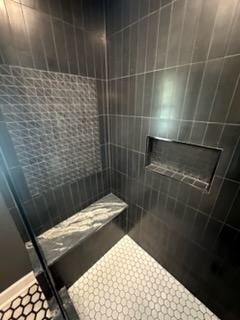 Bathroom remodel with dark slate tile shower bench