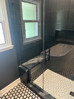 Bathroom remodel with dark slate tile shower and soaking tub