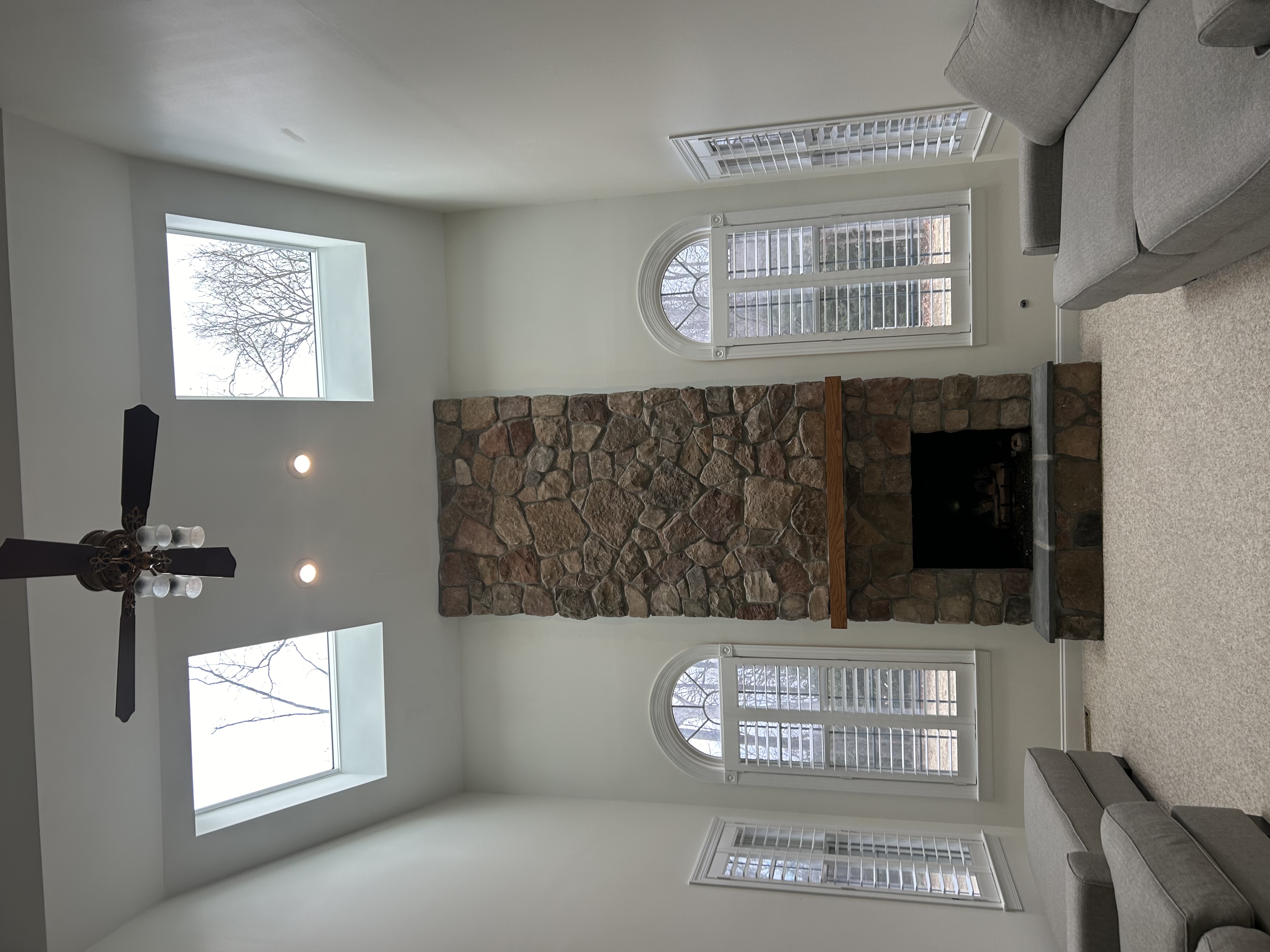 Finished vaulted living room with new skylights and stone fireplace